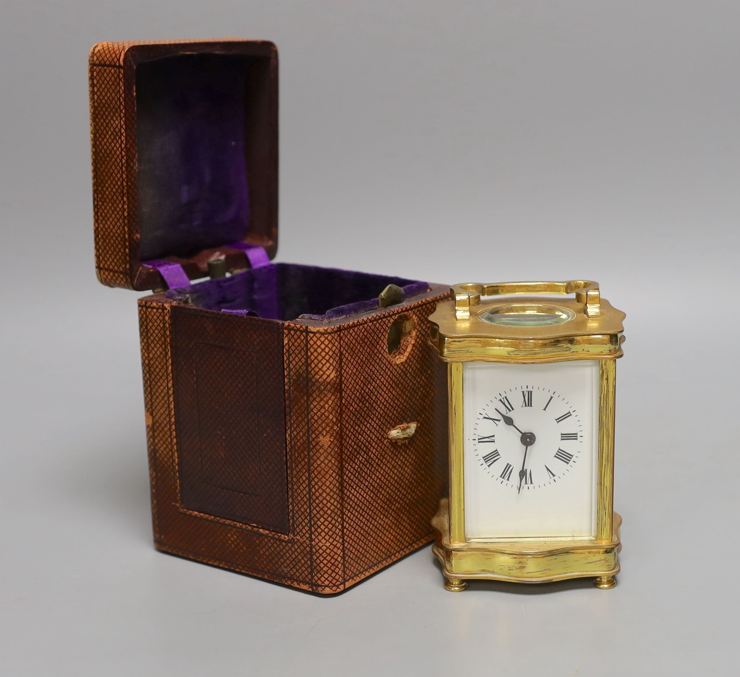 A French brass cased carriage timepiece with case. 11cm